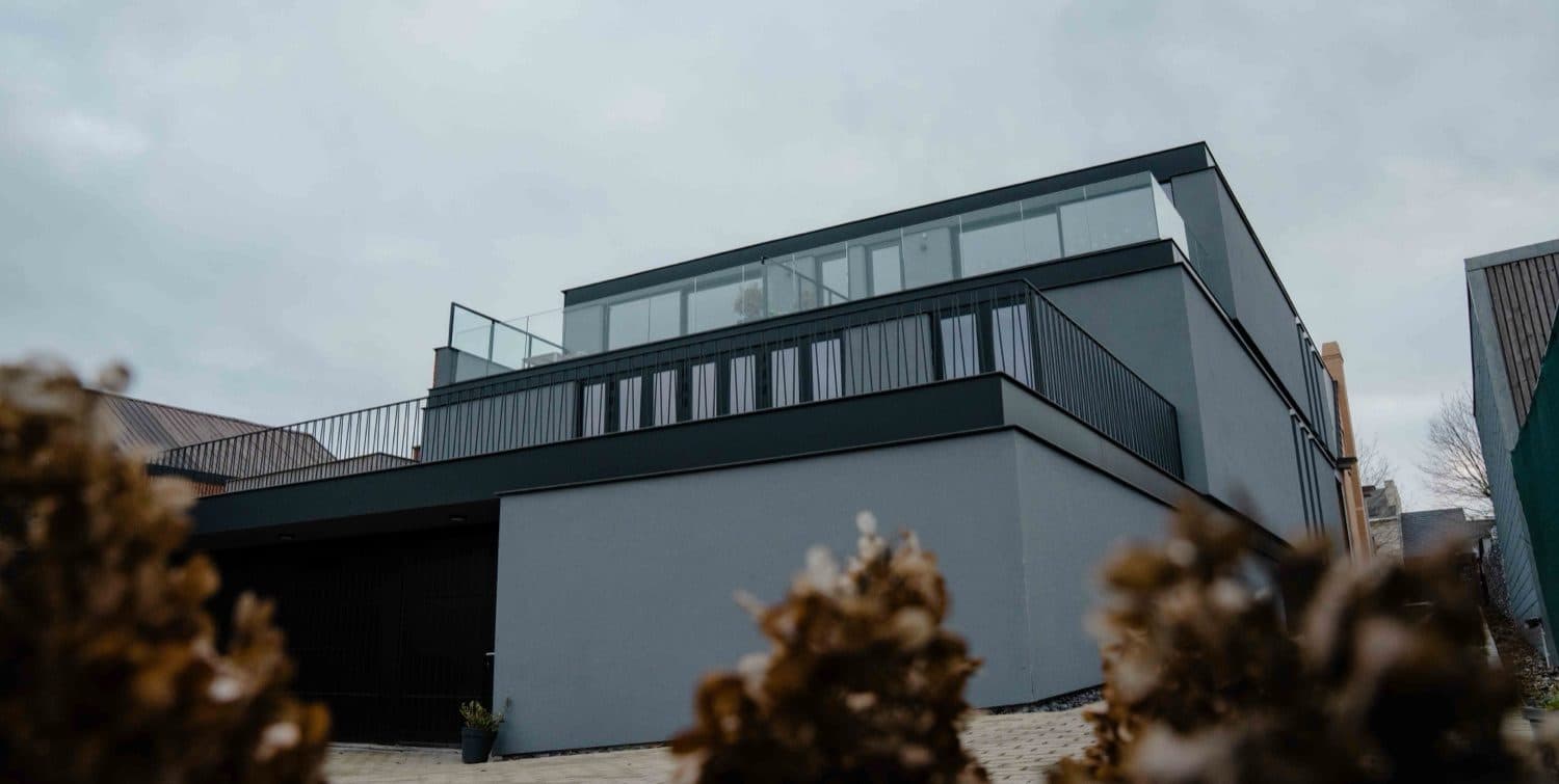Dakterras met glazen en stalen V-balustrade op een modern gebouw